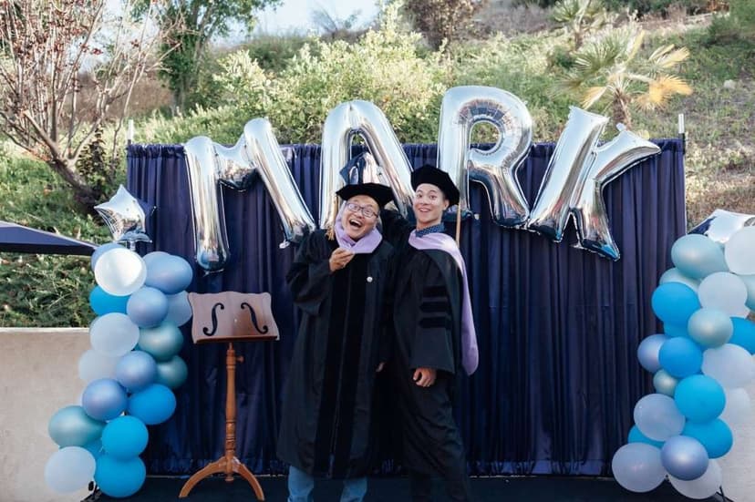 Dr. Mark Wang at his graduation ceremony with his father, celebrating two generations of dentistry